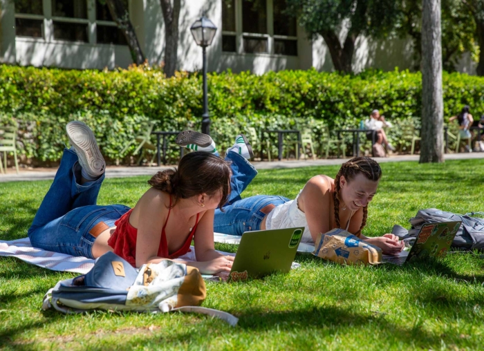 Two student studying on Elm Tree Lawn