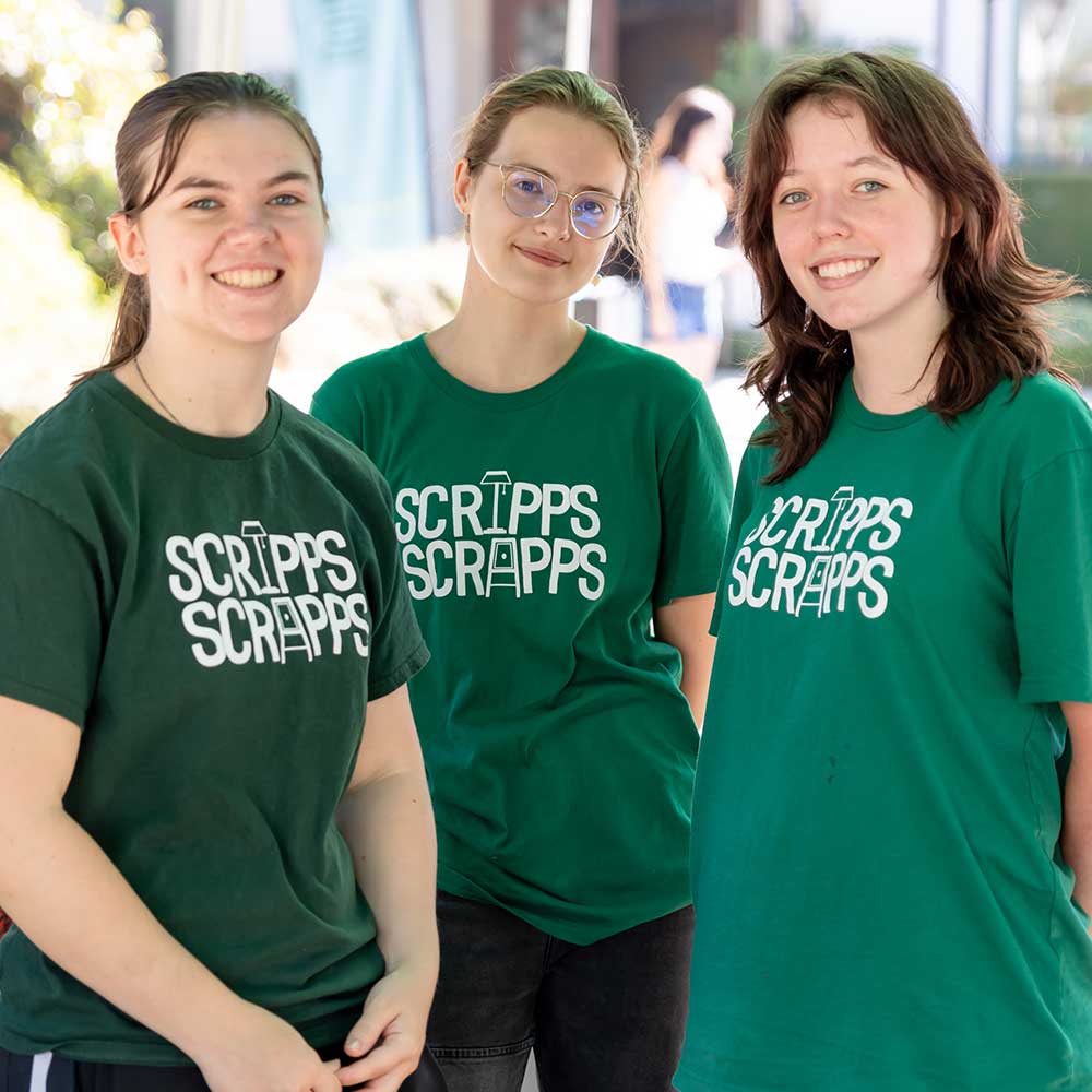 Three students smiling wearing Scripps Scrapps shirts