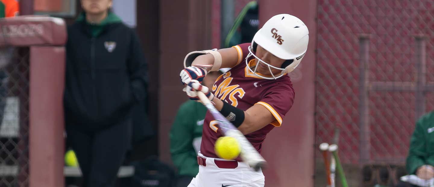 Softball player hitting ball