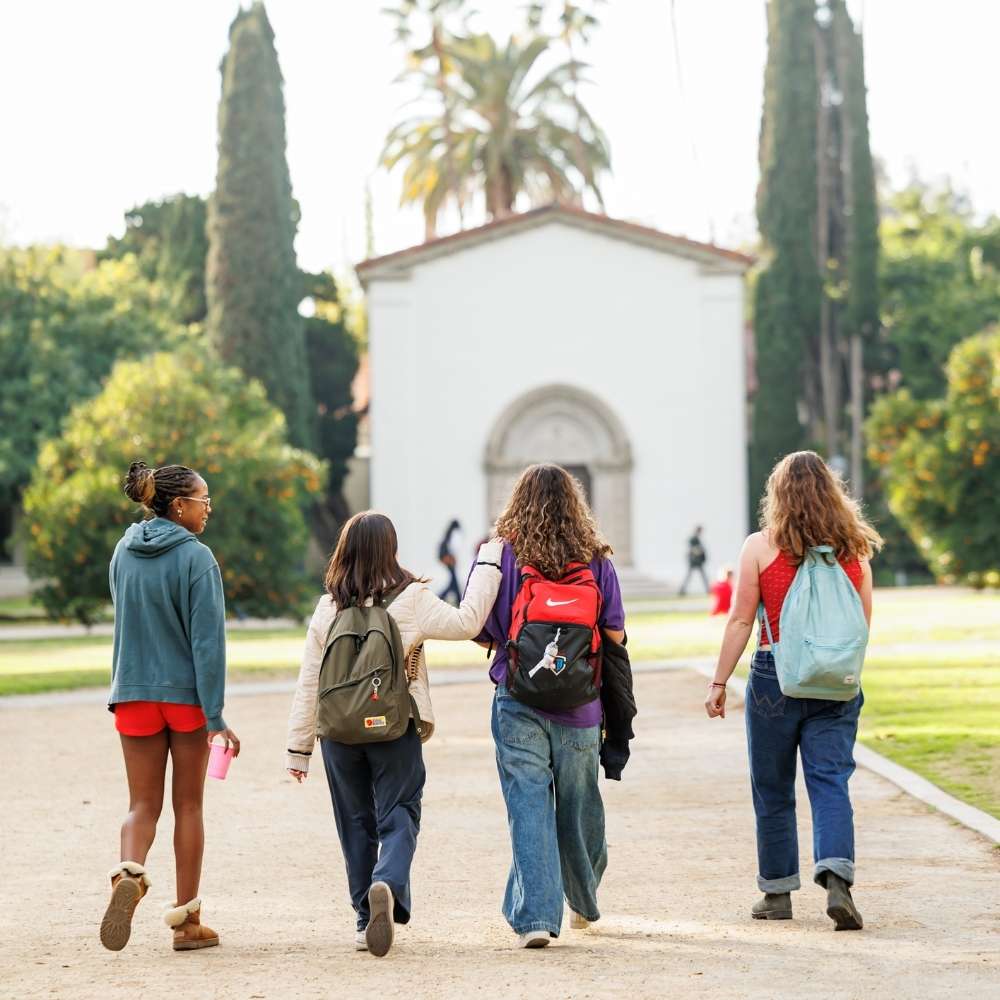 four scripps students walking on campus toward Balch Hall