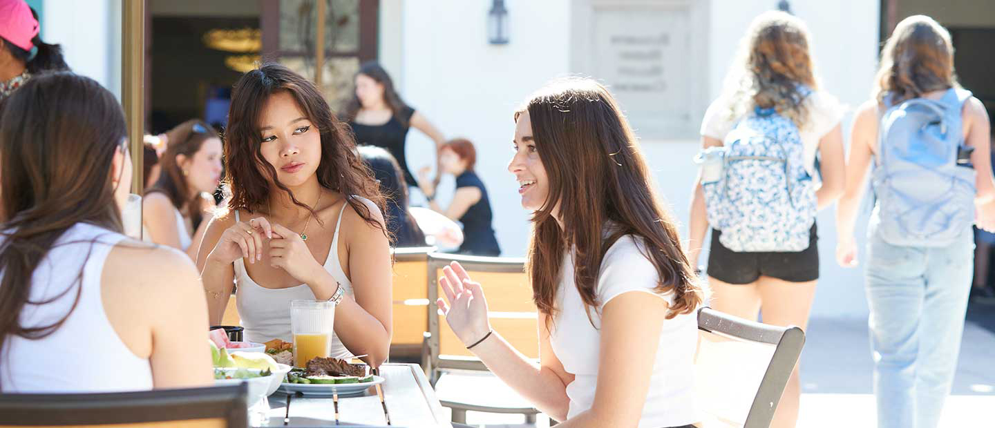 Students eating lunch outside at dining hall.